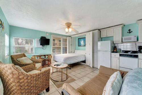a living room with a couch and a kitchen at The Seashell Suite with Private Balcony and Walk to Beach in Clearwater Beach