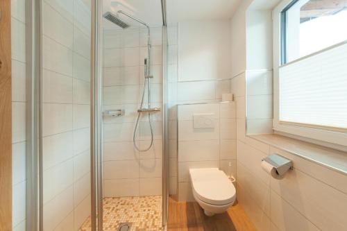 a bathroom with a shower and a toilet at Stöcklhof in Pettneu am Arlberg