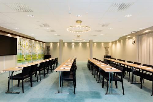 a row of tables and chairs in a room at ProfilHotels Aveny in Umeå