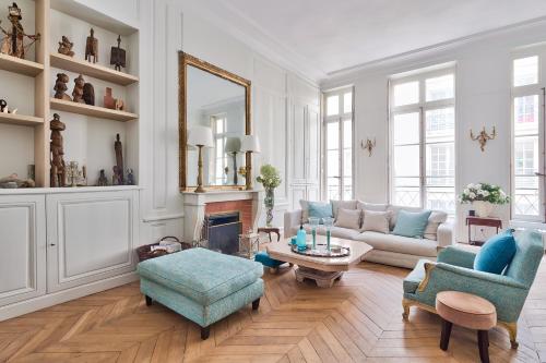 a living room with a couch and a table at Appartement de standing sur l'île Saint-Louis by Weekome in Paris