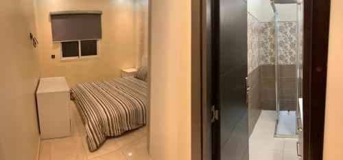 a small bedroom with a bed and a window at Petite Villa de 160m2 à Mohammedia in Mohammedia