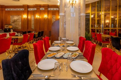 a dining room with a table and red chairs at Wyndham Istanbul Old City in Istanbul