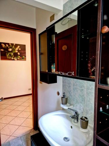 a bathroom with a white sink and a mirror at CASA BOUNTY in Trieste