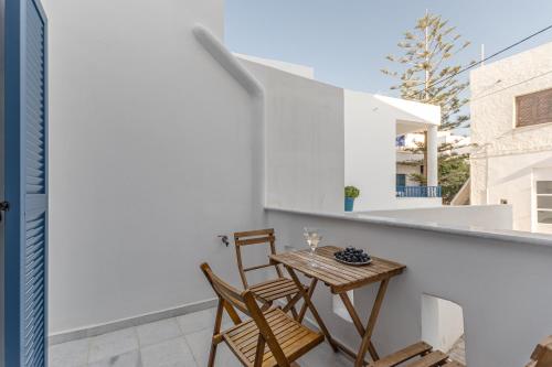 a small table and two chairs on a balcony at Optasia - Naxos Center Cozy House in Naxos Chora