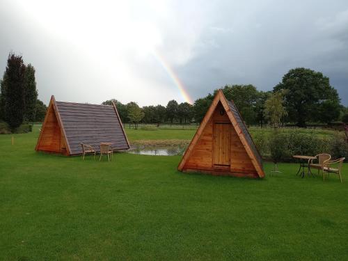 two small tents with a rainbow in the background at Achterhoeks Goed, Minicamping in Vragender in Vragender