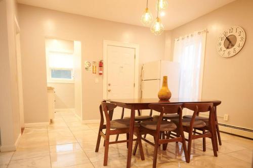 a dining room table with chairs and a vase on it at Cozy apartment 2nd 10min Walk Downtown and City View in Providence