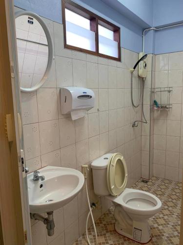 a bathroom with a toilet and a sink and a shower at AtMyHomeStay Bangsaphan in Bang Saphan