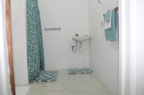 a bathroom with a sink and a shower curtain at Comfort Air B & B in Mount Gay