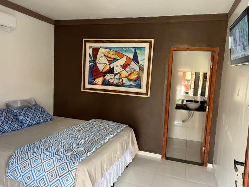 - une chambre avec un lit et une peinture murale dans l'établissement Pousada Marina, à Barreirinhas