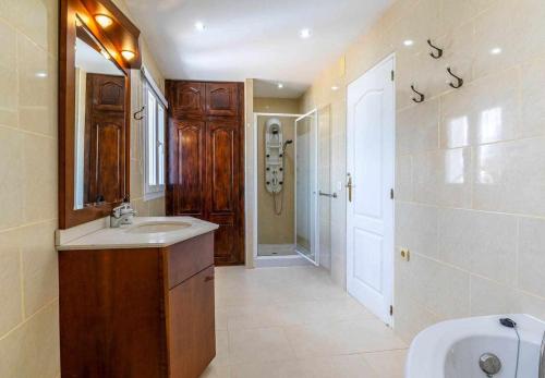 a bathroom with a sink and a toilet and a mirror at Inftour La Fustera A Apartamento in Benissa