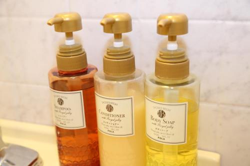 three bottles of oils sitting on a table at Niigata Toei Hotel in Niigata