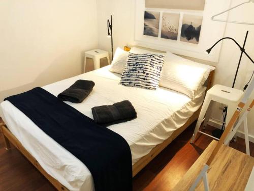 a bed with two pillows on it in a room at The Central Shed - 10B in Geraldton