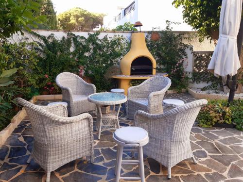 a group of chairs and a table on a patio at House in the center of albir, 2 min walk from the beach in Albir