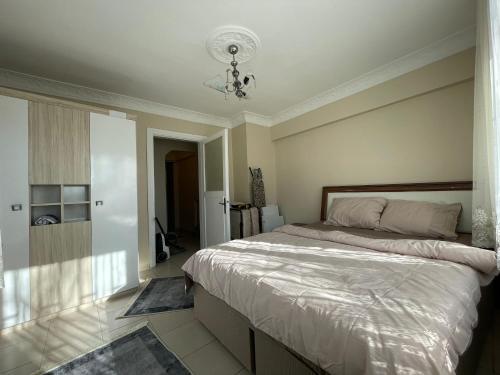 a bedroom with a large bed and a chandelier at Taksim house in Istanbul