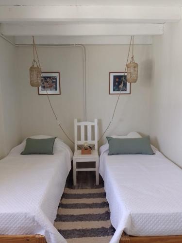 two beds sitting next to each other in a room at CABAÑA LAUTARO in Las Grutas