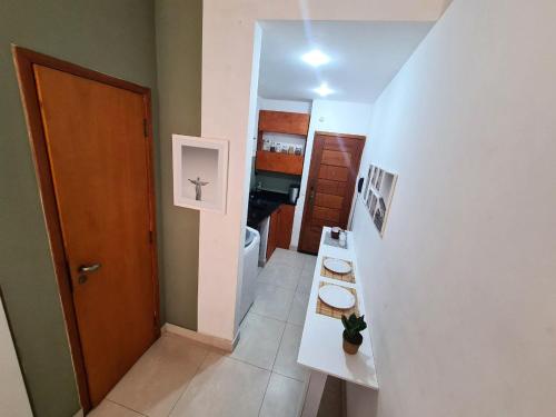 a small bathroom with a toilet and a hallway at Apto Versátil Praia de Botafogo in Rio de Janeiro