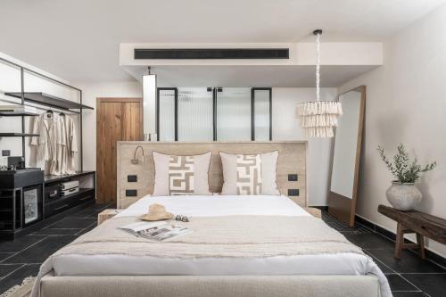 a bedroom with a large white bed with pillows at Pereh Mountain Resort in Gadot