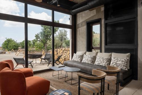 a living room with a couch and some chairs at Pereh Mountain Resort in Gadot