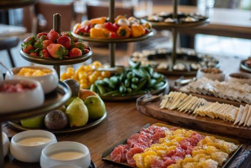 a table topped with lots of different types of food at Pereh Mountain Resort in Gadot