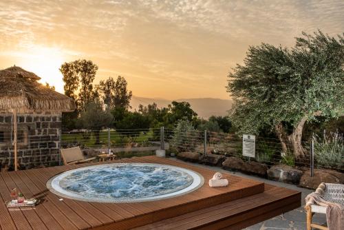 a hot tub on a deck in a backyard at Pereh Mountain Resort in Gadot