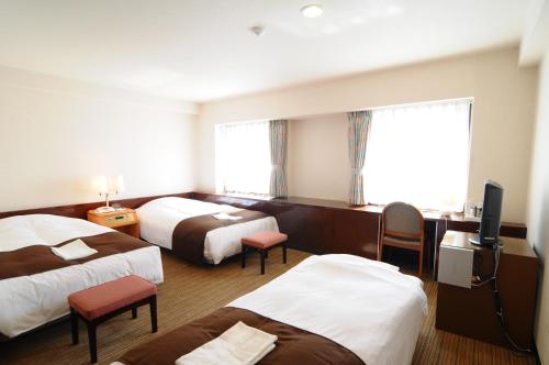 Postel nebo postele na pokoji v ubytování Niigata Toei Hotel