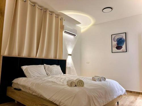 a bedroom with a bed with two towels on it at Deja Vu suite . Feel like Home in Majdal Shams