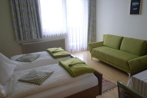 a small bedroom with a bed and a couch at Edelsteinhotel Guniwirt in Krakaudorf