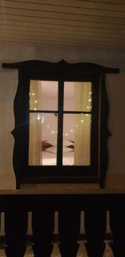 a view through a window of a room at Pensiunea Bradet in Broşteni