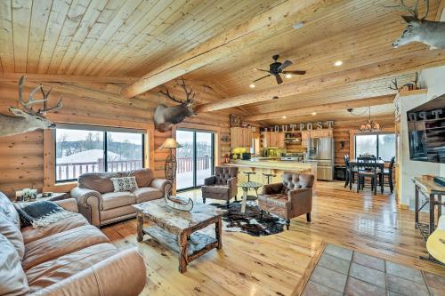 a living room with a couch and a table at Charming Bedford Cabin with Private Hot Tub! in Thayne