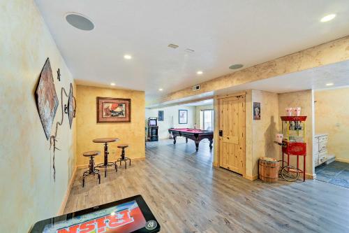 a living room with a ping pong table and a pool table at Charming Bedford Cabin with Private Hot Tub! in Thayne