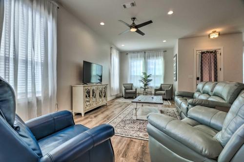 a living room with couches and a flat screen tv at Spacious Gulfport Home - Walk to Beach! in Gulfport