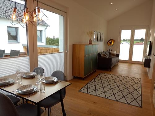 Un comedor con una mesa y una sala de estar. en Ferienwohnung Mundry, en Täferrot