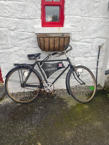 a bike parked next to a building with a basket at Nellie's Farmhouse in Carlingford