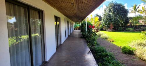 a walkway outside of a building with a porch at Hotel Puku Vai in Hanga Roa