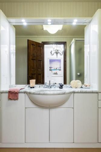 a bathroom with a sink and a large mirror at Caprera Flexyrent NO air conditioning - Seafront in Santa Margherita Ligure