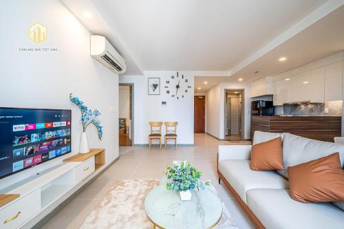 a living room with a couch and a tv at Cozy Apartment, City Center , The Goldview D4 in Ho Chi Minh City