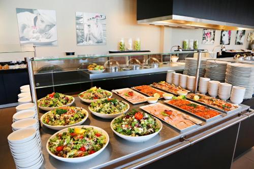 a buffet line with many different salads and food at Van Der Valk Hotel Almere in Almere