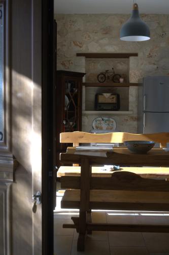 a kitchen with a table with books on it at LIORIZA Country Houses in Kalamaki