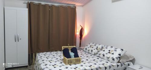 a bedroom with a bed with blue chairs in it at Recanto do Luar in São Miguel do Gostoso