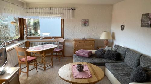 a living room with a couch and a table at Ferienwohnung Panoramablick in Bolsterlang