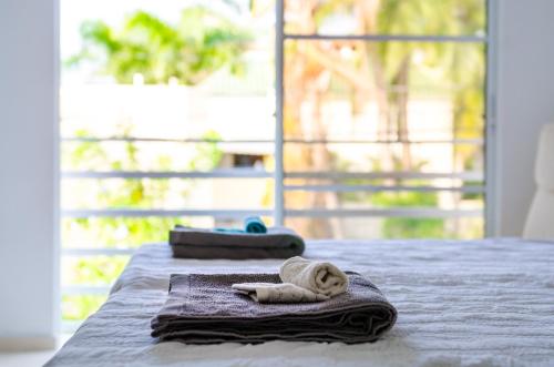 a pair of towels sitting on top of a bed at Art Villa in Punta Cana