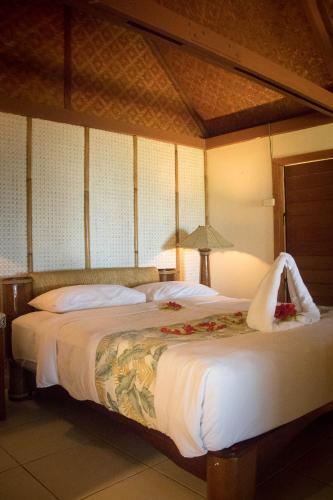 a bedroom with two beds with flowers on them at Beqa Lagoon Resort in Beqa Island