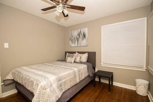 a bedroom with a bed and a ceiling fan at Home Sweet Home Bungalow in North Little Rock