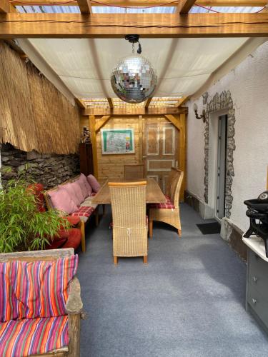 a patio with a wooden table and chairs at Casa Siepelunga in Villmar