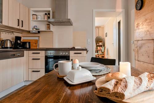 a kitchen with a wooden table with a counter top at Spechtnest in Naumburg