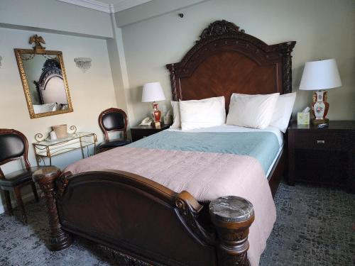a bedroom with a large bed and two chairs at Lowell Inn in Stillwater