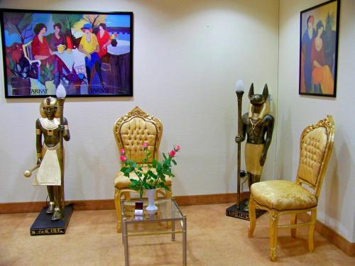 a room with statues and chairs in a museum at Hotel Amadeus ROYAL Berlin in Berlin