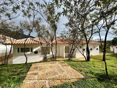 a house with a yard with trees in front of it at Victorias Villas in Villa de Leyva