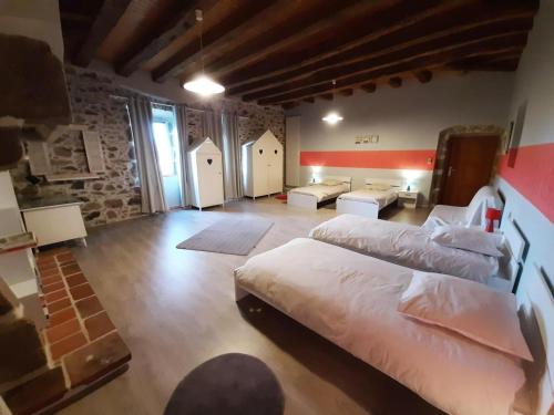 a large bedroom with two beds and a living room at Gîte spacieux avec piscine privative, grand jardin et équipements bébé en Charente Limousine - FR-1-653-67 in Esse