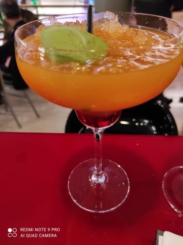 a drink in a glass on a red table at Sea Art Hotel in Vado Ligure